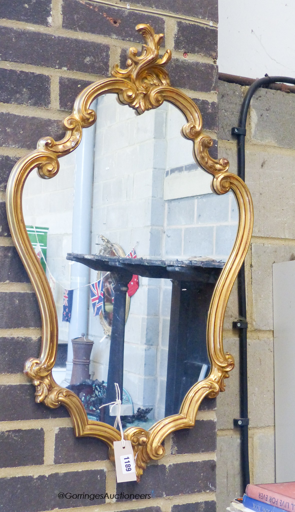 A reproduction rococo gilt mirror. W-48, H-84cm.